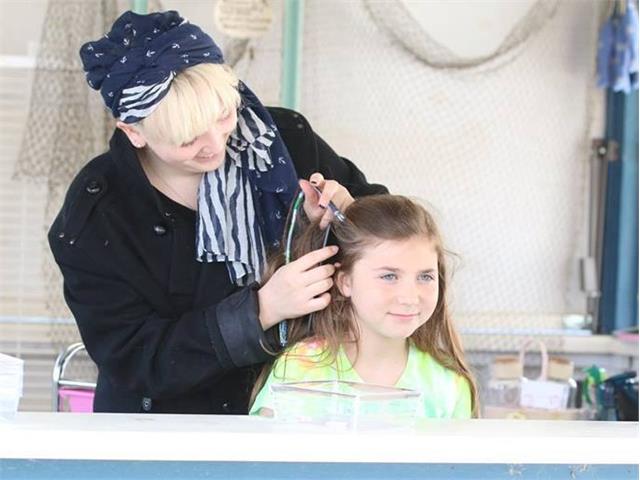 Summer Company business owner braids girl's hair