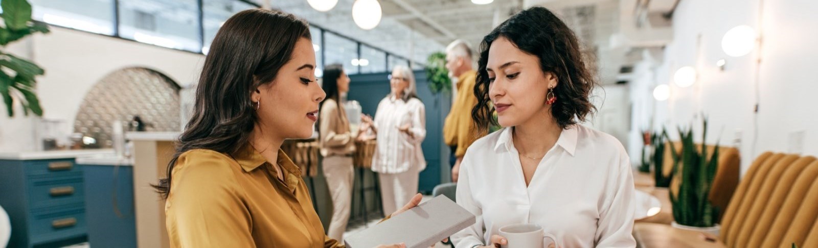 Two women chat in an office