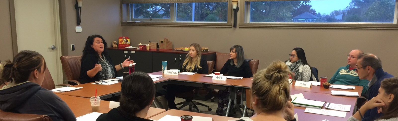 Group sits around the table during a BECN seminar