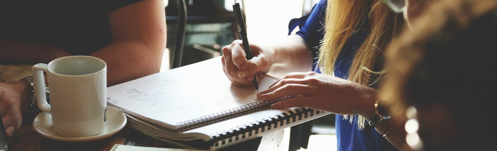 Close up of hand writing on a paper